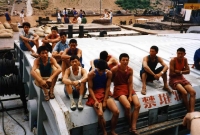 Another view of the young Chinese dock workers in their multi-colored t-shirts.