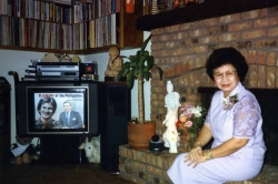 Mom in living room of house, early 1990s.