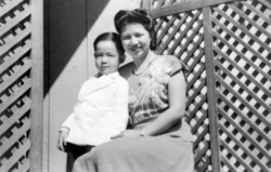 Paul with Mom outside house in Chinatown, 1949.