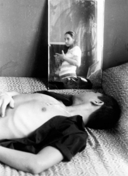 Paul at home in bedroom with reflection of Joan Cuadra.