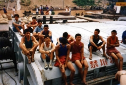 Another view of the young Chinese dock workers in their multi-colored t-shirts.