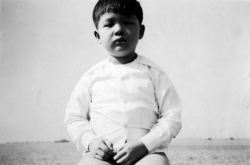 Paul on seawall at Dewey Blvd. by Manila Bay, 1949.